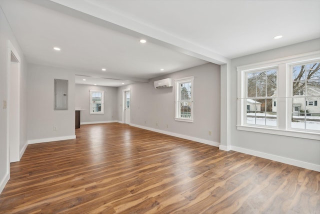 unfurnished living room featuring dark hardwood / wood-style flooring, electric panel, and a wall mounted AC