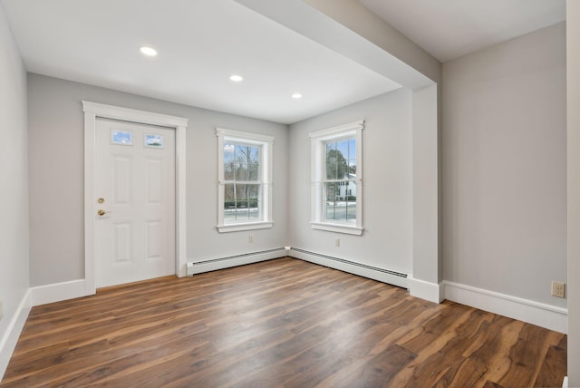 foyer entrance with baseboard heating and dark hardwood / wood-style floors