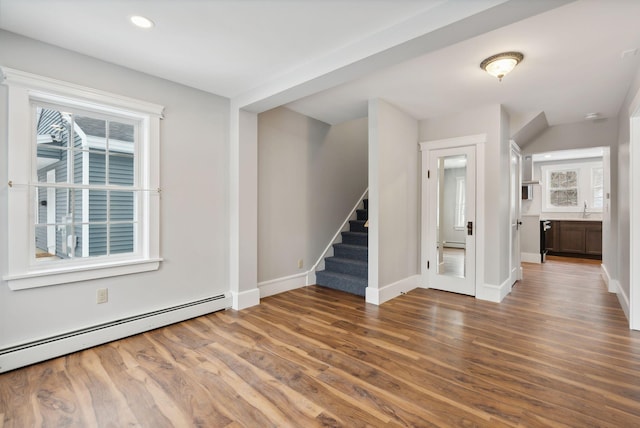 interior space featuring dark hardwood / wood-style floors, sink, and baseboard heating