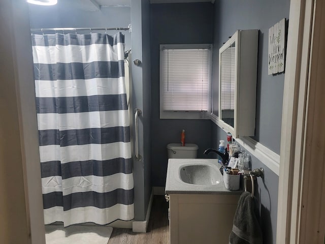 bathroom featuring a shower with curtain, hardwood / wood-style floors, vanity, and toilet