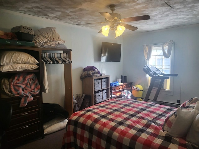 bedroom featuring ceiling fan and a textured ceiling