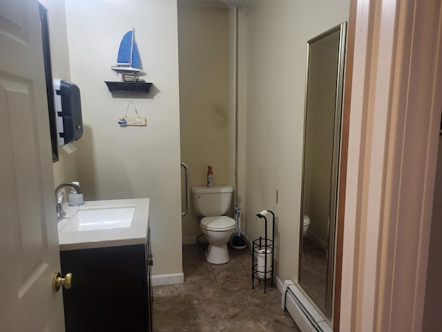 bathroom featuring baseboard heating, a shower with door, vanity, and toilet