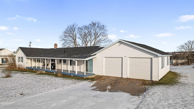 ranch-style home with covered porch and a garage