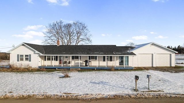 ranch-style home with covered porch and a garage