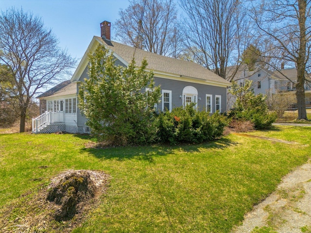 10 Nokomis Rd, Corinna, ME 04928 - view of property exterior with a lawn, a chimney, and a shingled roof