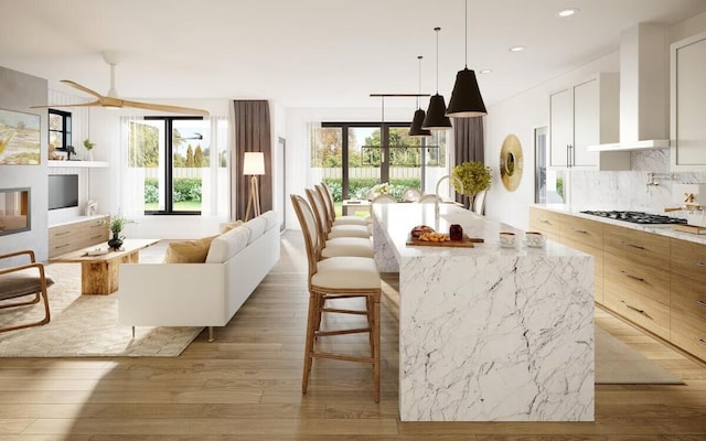 kitchen featuring a wealth of natural light, a center island, and light wood-type flooring