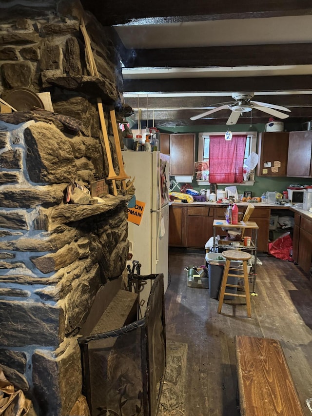 kitchen featuring beamed ceiling, dark hardwood / wood-style flooring, white refrigerator, and ceiling fan