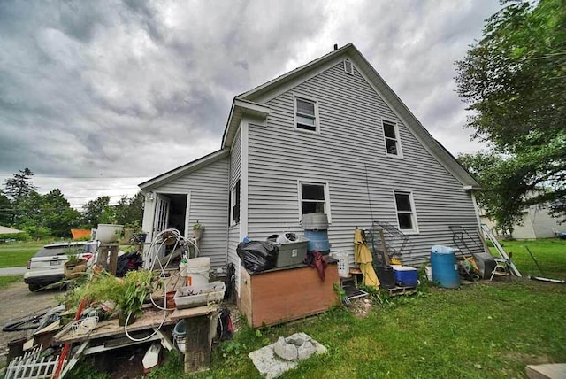 rear view of property with a yard