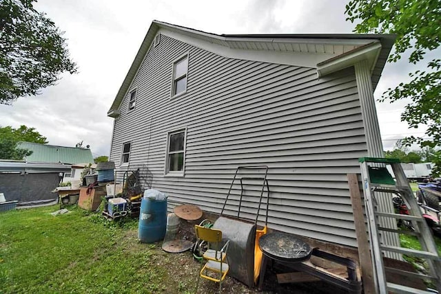 view of property exterior featuring a lawn