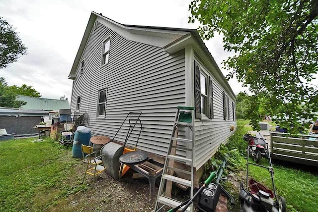 view of side of property with a yard