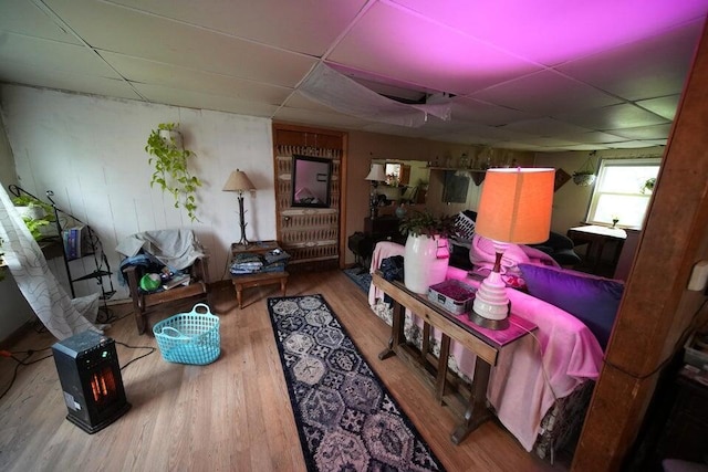 interior space with a paneled ceiling and wood-type flooring