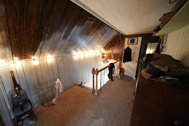 interior space with wooden ceiling, wood walls, carpet floors, and vaulted ceiling