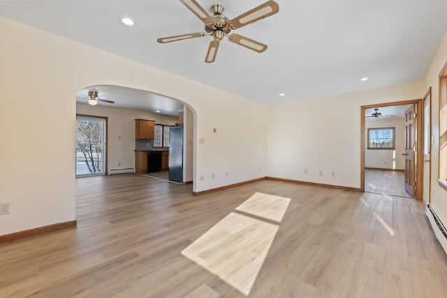 unfurnished living room featuring light hardwood / wood-style flooring, a baseboard radiator, and ceiling fan