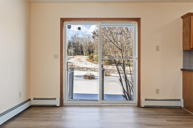 entryway with baseboard heating and light wood-type flooring