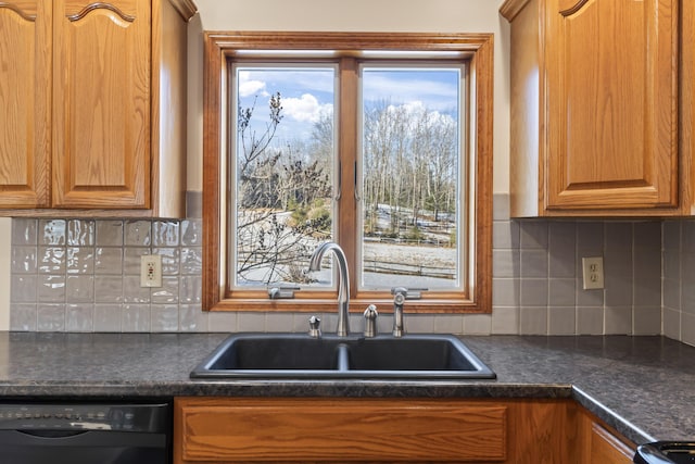 kitchen with tasteful backsplash, black dishwasher, and sink