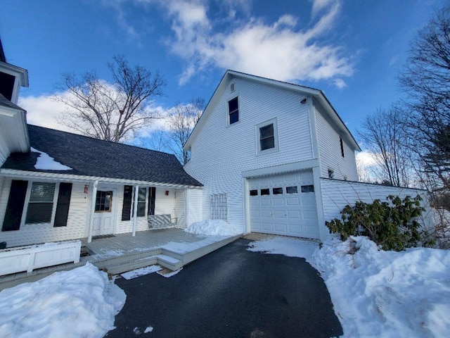 view of front of home featuring a porch and a garage