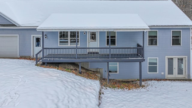 snow covered house with a garage