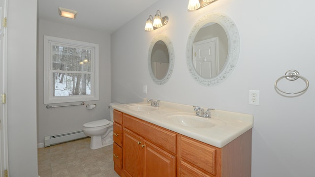 bathroom featuring baseboard heating, vanity, and toilet