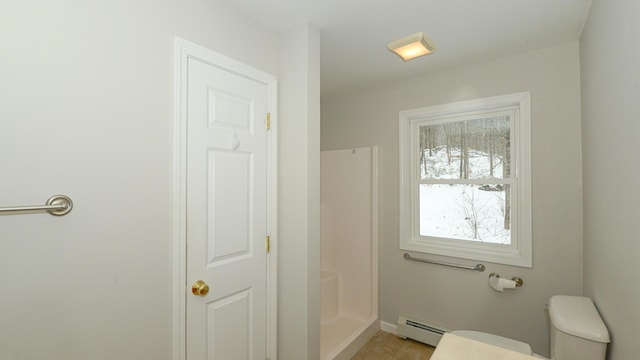 bathroom with toilet, walk in shower, and a baseboard heating unit