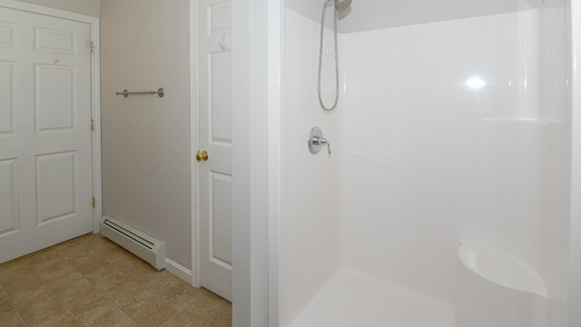 bathroom featuring baseboard heating and a shower