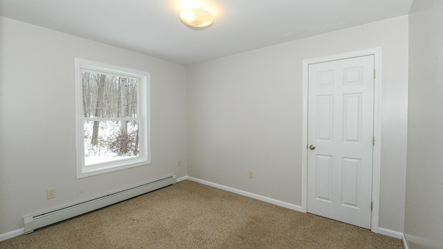 unfurnished room featuring carpet and a baseboard heating unit