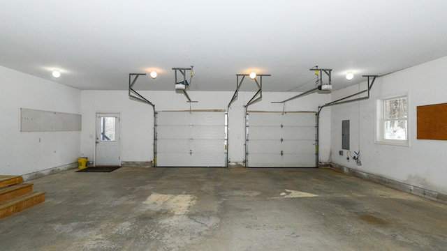 garage featuring electric panel and a garage door opener