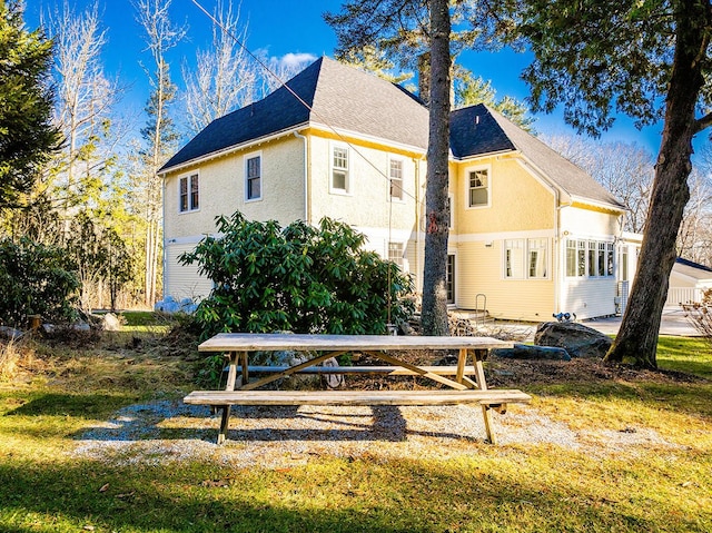 view of side of home with a lawn