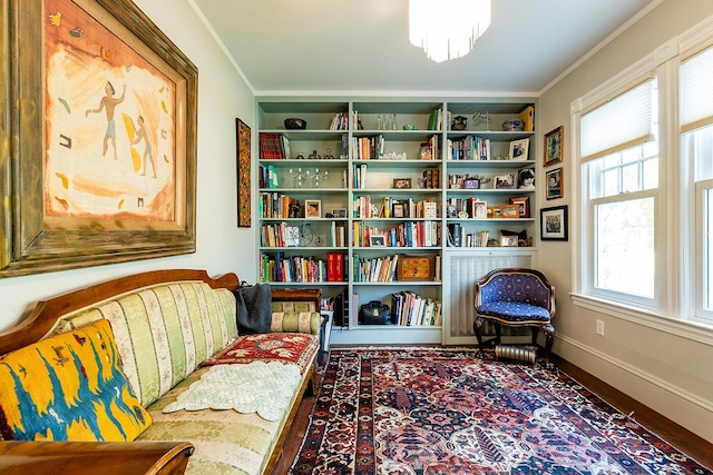 sitting room featuring an inviting chandelier and ornamental molding