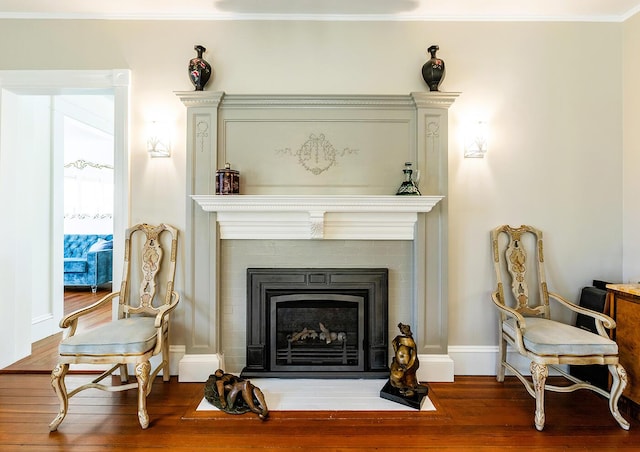 sitting room featuring hardwood / wood-style flooring and ornamental molding