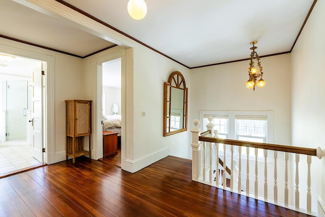 interior space with a chandelier, dark hardwood / wood-style floors, and ornamental molding