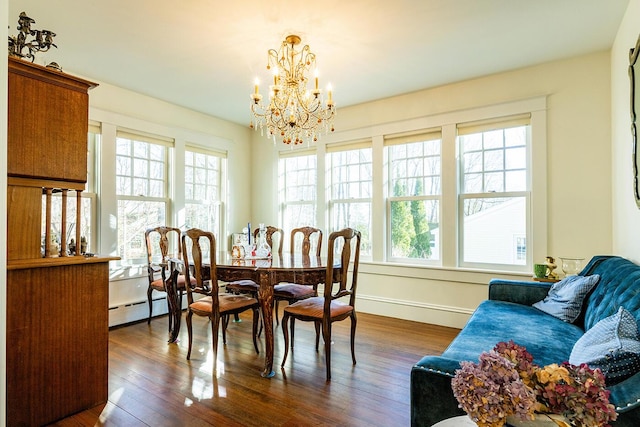 dining room with a chandelier, dark wood-type flooring, and a baseboard radiator