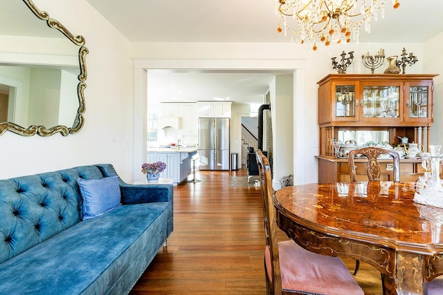 dining area featuring dark hardwood / wood-style flooring and a chandelier