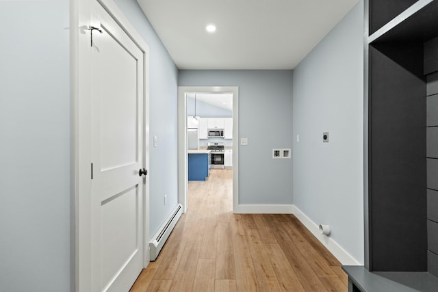 hallway with hardwood / wood-style flooring and a baseboard heating unit