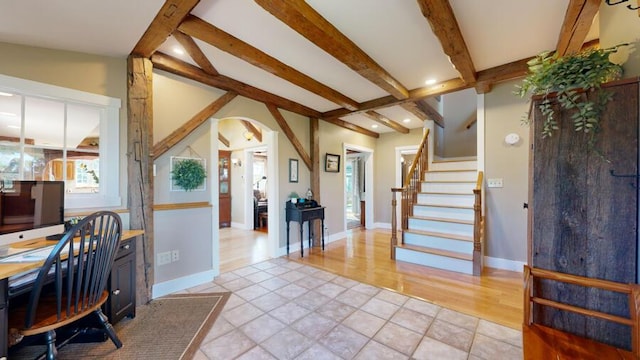 office space featuring lofted ceiling with beams and light hardwood / wood-style flooring