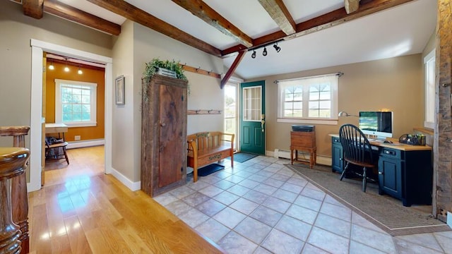 office area with light hardwood / wood-style floors, a wealth of natural light, and a baseboard heating unit