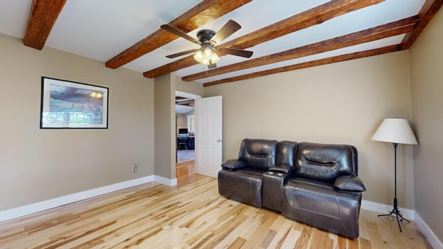 living room with beam ceiling, light hardwood / wood-style flooring, and ceiling fan