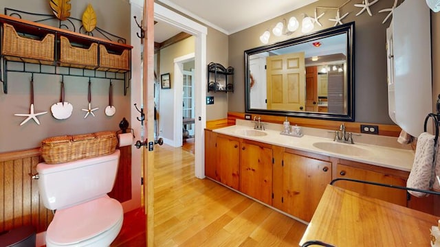 bathroom featuring hardwood / wood-style floors, vanity, toilet, and crown molding