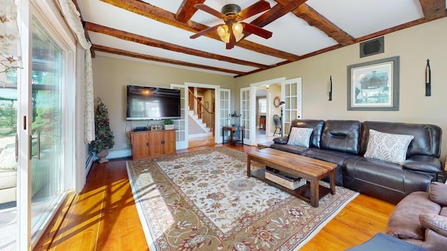 living room featuring french doors, baseboard heating, ceiling fan, wood-type flooring, and beamed ceiling