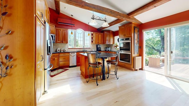 kitchen featuring a center island, light hardwood / wood-style flooring, a healthy amount of sunlight, and backsplash