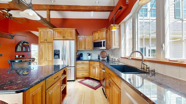 kitchen featuring sink, pendant lighting, plenty of natural light, and appliances with stainless steel finishes