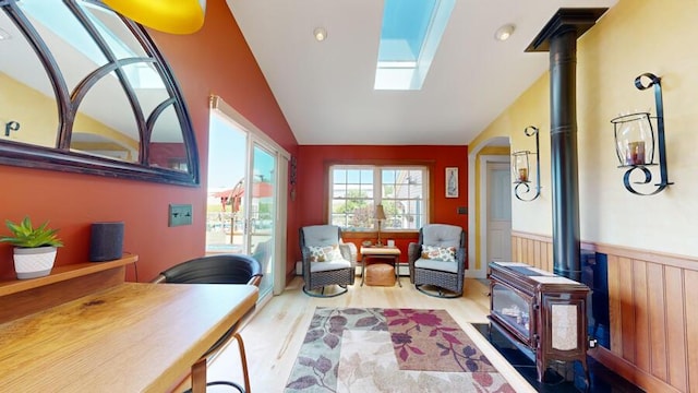 interior space with light hardwood / wood-style floors and lofted ceiling with skylight