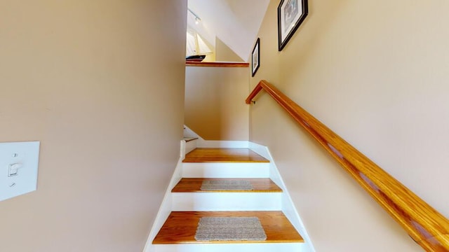 stairs featuring hardwood / wood-style floors