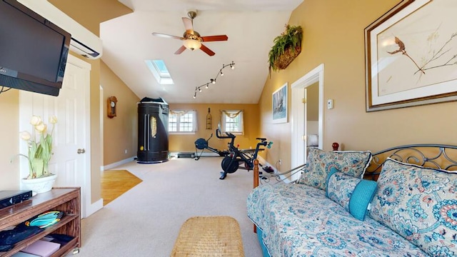 bedroom featuring lofted ceiling with skylight, carpet, and ceiling fan