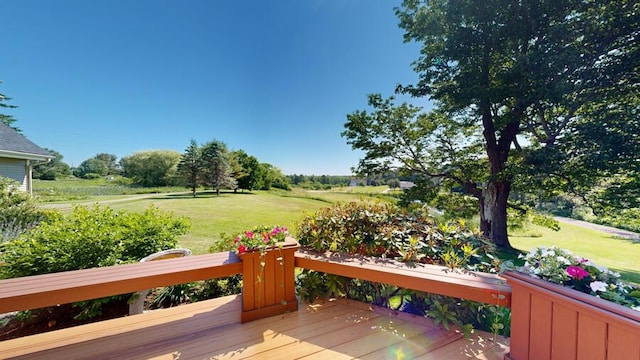 wooden terrace featuring a yard