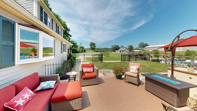 view of patio featuring an outdoor living space with a fire pit