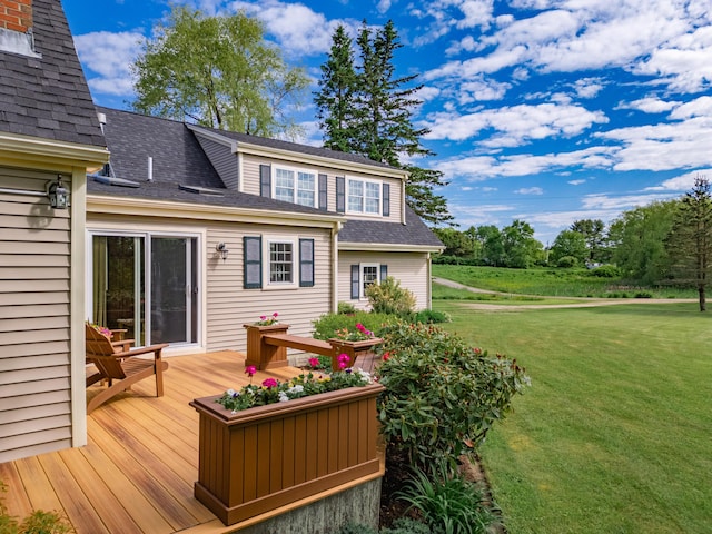 exterior space with a lawn and a wooden deck