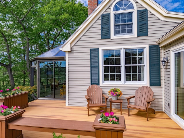 wooden terrace featuring a sunroom