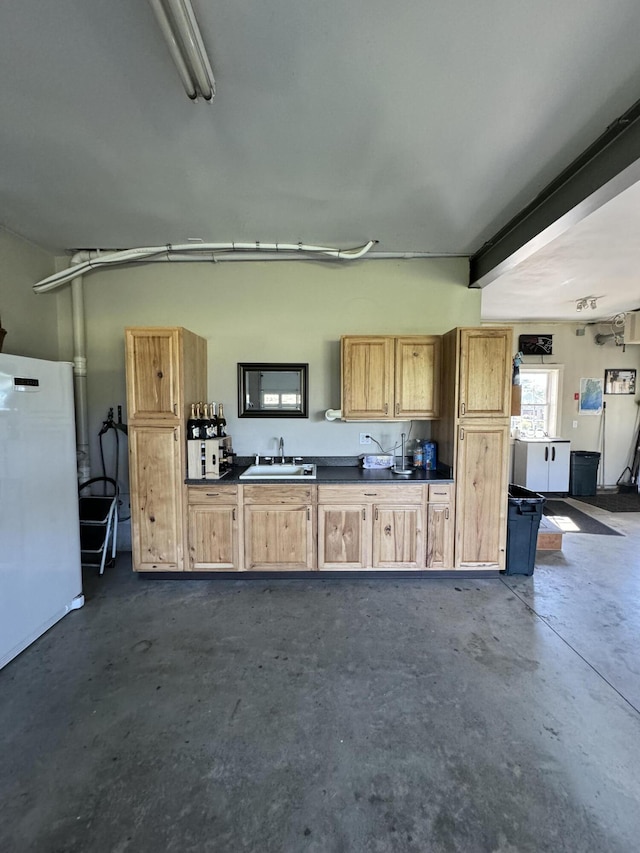 garage featuring white refrigerator and sink