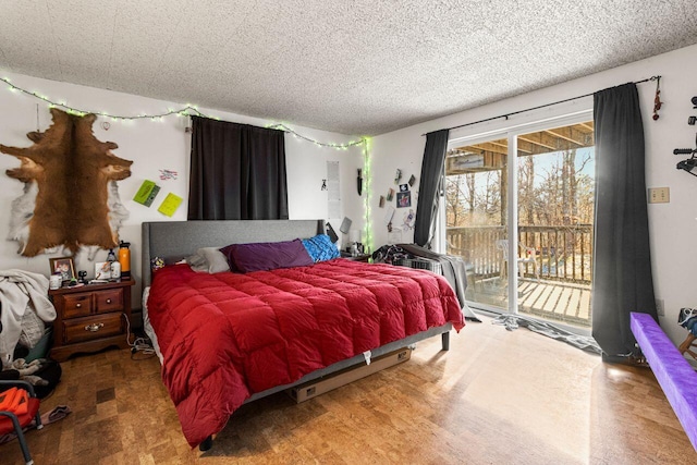 bedroom featuring access to outside and a textured ceiling