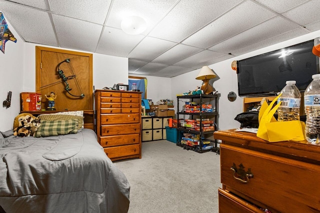 carpeted bedroom with a paneled ceiling